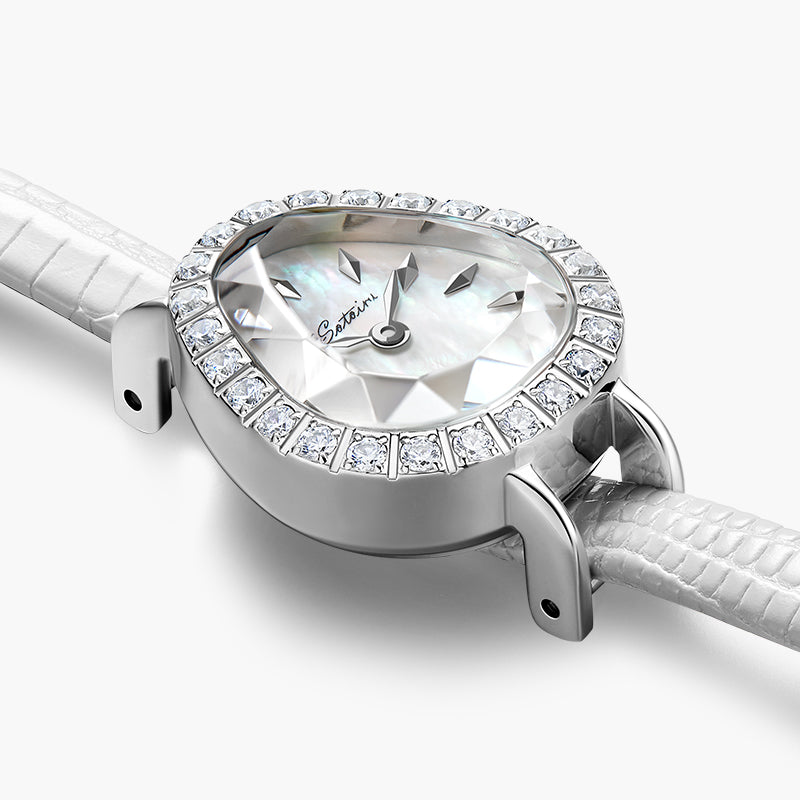Close-up of Sotoiru women's watch: silver teardrop case with sparkling zircons, highlighting the iridescent mother-of-pearl dial and faceted prism crystal glass.
